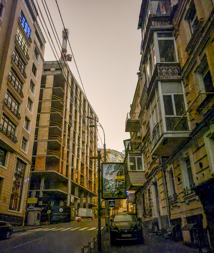 The lights of multi-story beige-stone apartment blocks go dark during daily scheduled blackouts in Ukraine.