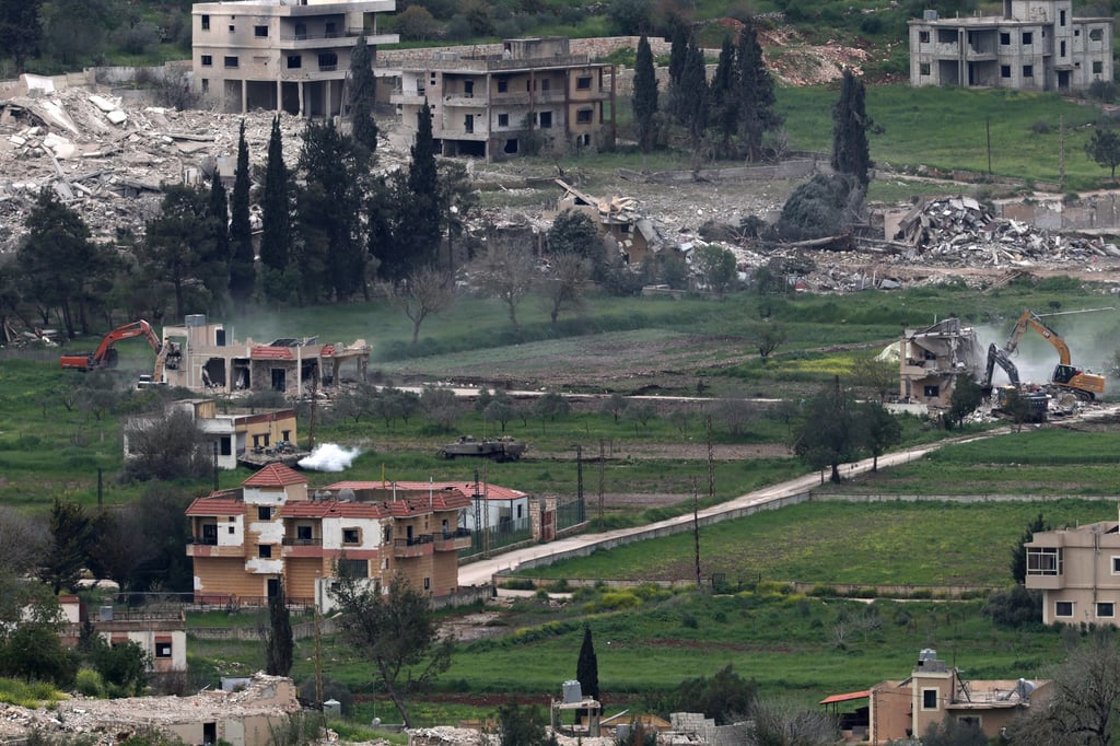 Israeli armoured personnel carriers guard excavators demolishing buildings in the southern Lebanese village of Mais al-Jabal, as seen from the Israeli side of the border, on Wednesday. Photo: EPA Israeli armoured personnel carriers guard excavators demolishing buildings in the southern Lebanese village of Mais al-Jabal, as seen from the Israeli side of the border, on Wednesday. Photo: EPA