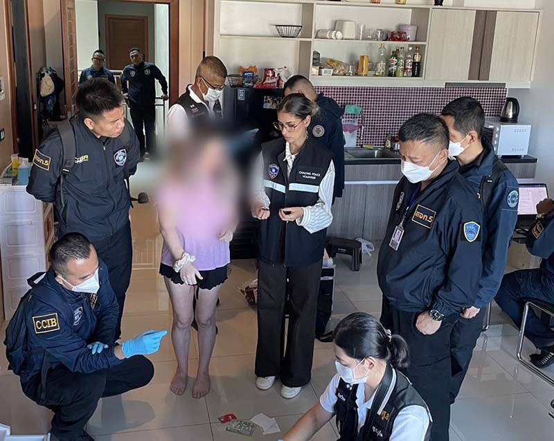 Photo showing multiple police officers and a blurred out woman in an apartment.