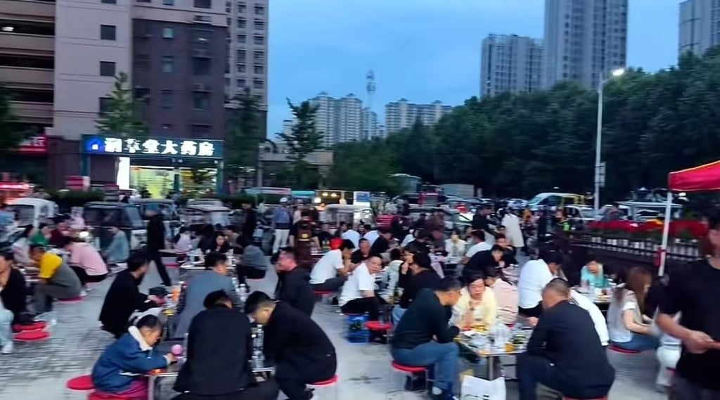 Customers throng the busy barbecue street stall as dusk approaches. Photo: Handout Customers throng the busy barbecue street stall as dusk approaches. Photo: Handout
