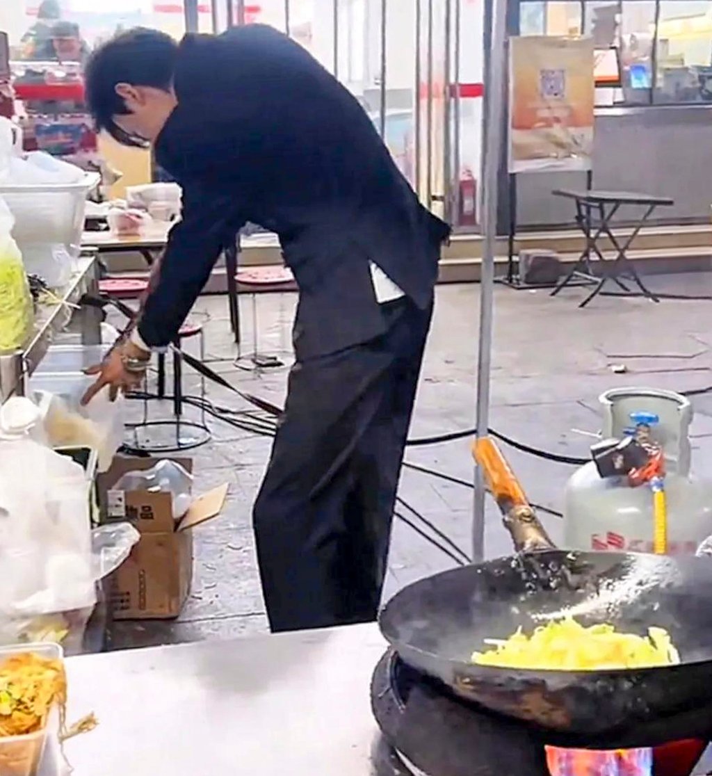 Lu, above, who has been running the stall for two years, checks on his ingredients. Photo: Sina