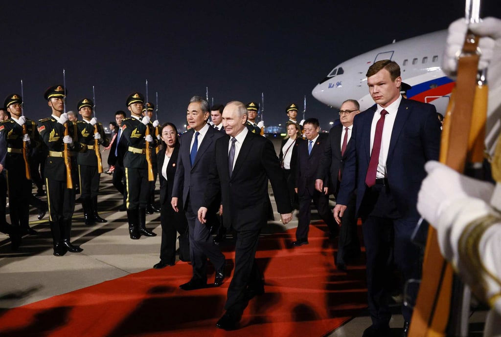 President Vladimir Putin is welcomed by Chinese Foreign Minister Wang Yi at Beijing Capital Airport late on Tuesday. Photo: AFP President Vladimir Putin is welcomed by Chinese Foreign Minister Wang Yi at Beijing Capital Airport late on Tuesday. Photo: AFP