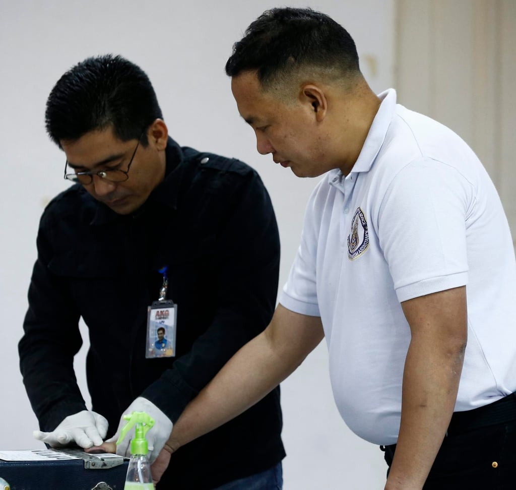 Former senior police officer Ricky Santa Isabel (right) is fingerprinted after his arrest for the killing of South Korean businessman Jee Ick-joo at the police headquarters in Quezon City in January 2017. Photo: EPA Former senior police officer Ricky Santa Isabel (right) is fingerprinted after his arrest for the killing of South Korean businessman Jee Ick-joo at the police headquarters in Quezon City in January 2017. Photo: EPA