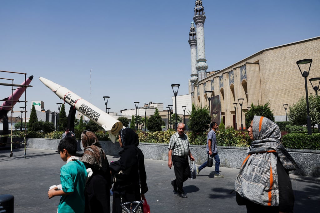 People walk next to a mock-up of an Iranian missile in Tehran on Thursday. Photo: Reuters People walk next to a mock-up of an Iranian missile in Tehran on Thursday. Photo: Reuters