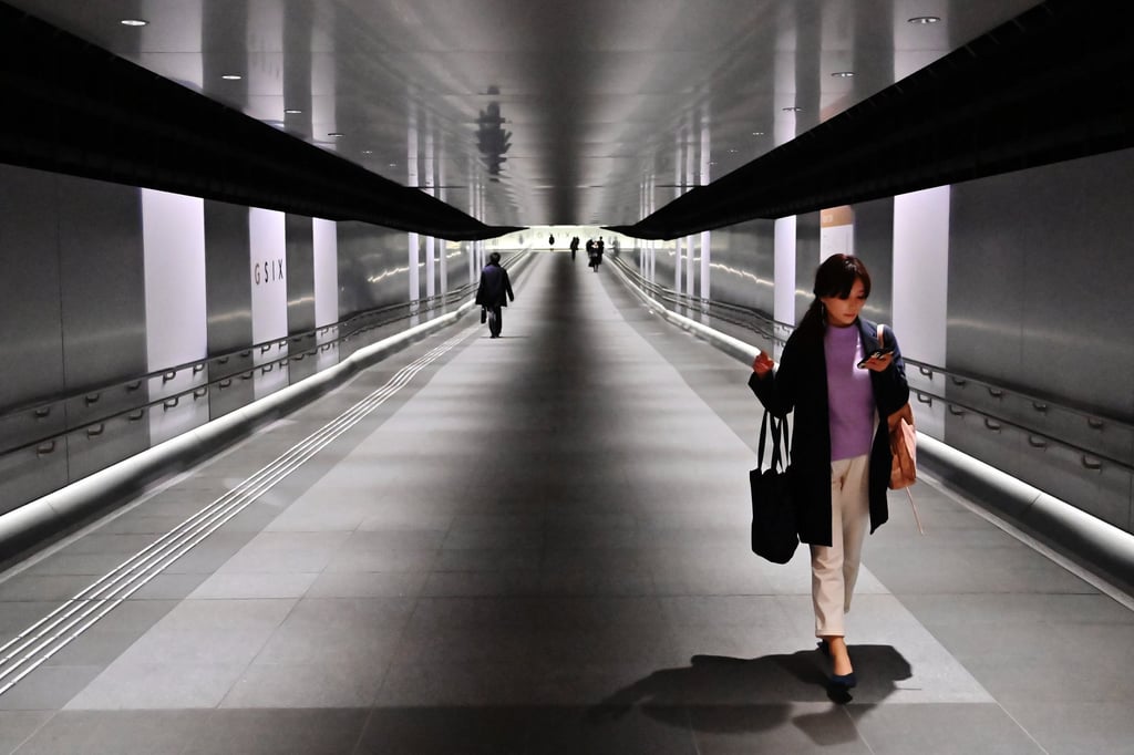 A woman walks through a corridor at Ginza railway station in Tokyo. Photo: AFP A woman walks through a corridor at Ginza railway station in Tokyo. Photo: AFP
