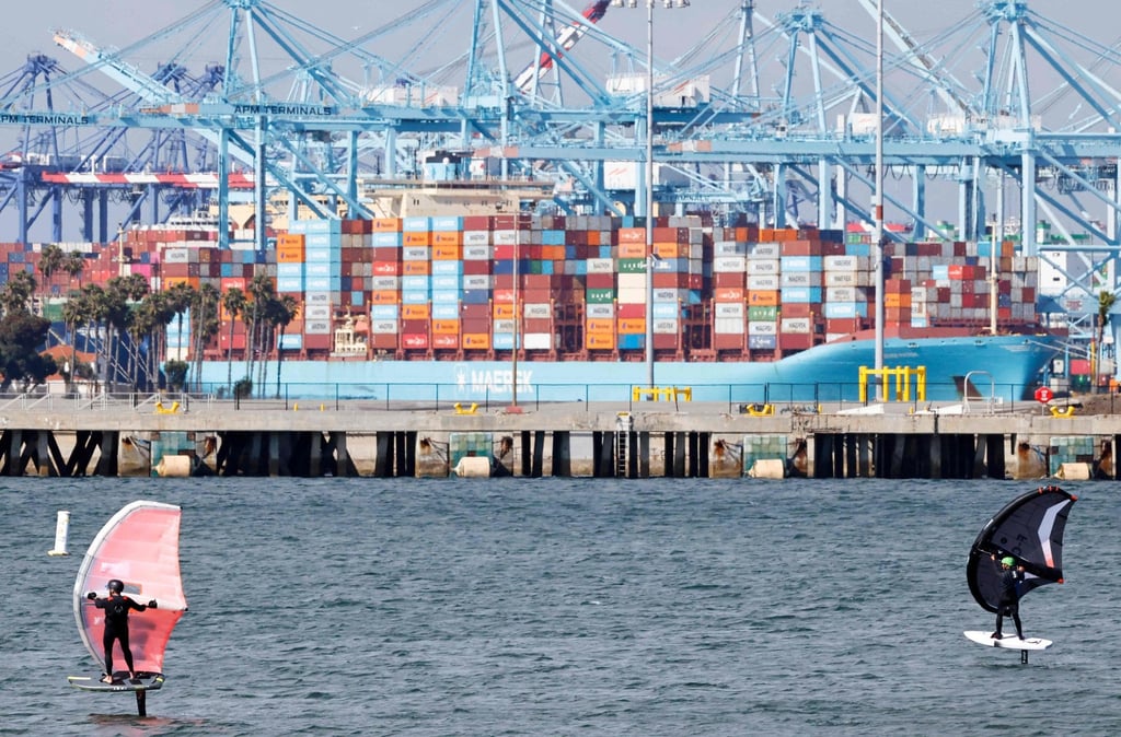 People ride wing foils near a container ship at the Port of Los Angeles on Thursday. Photo: AFP People ride wing foils near a container ship at the Port of Los Angeles on Thursday. Photo: AFP