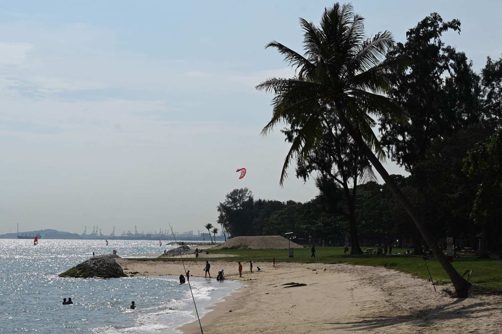People relax at a beach at East Coast Park in Singapore. Photo: AFP People relax at a beach at East Coast Park in Singapore. Photo: AFP