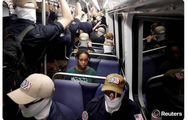 A lone tense Black woman rides the D.C. subway surrounded by masked Nazis in an "image that indicts an era."
