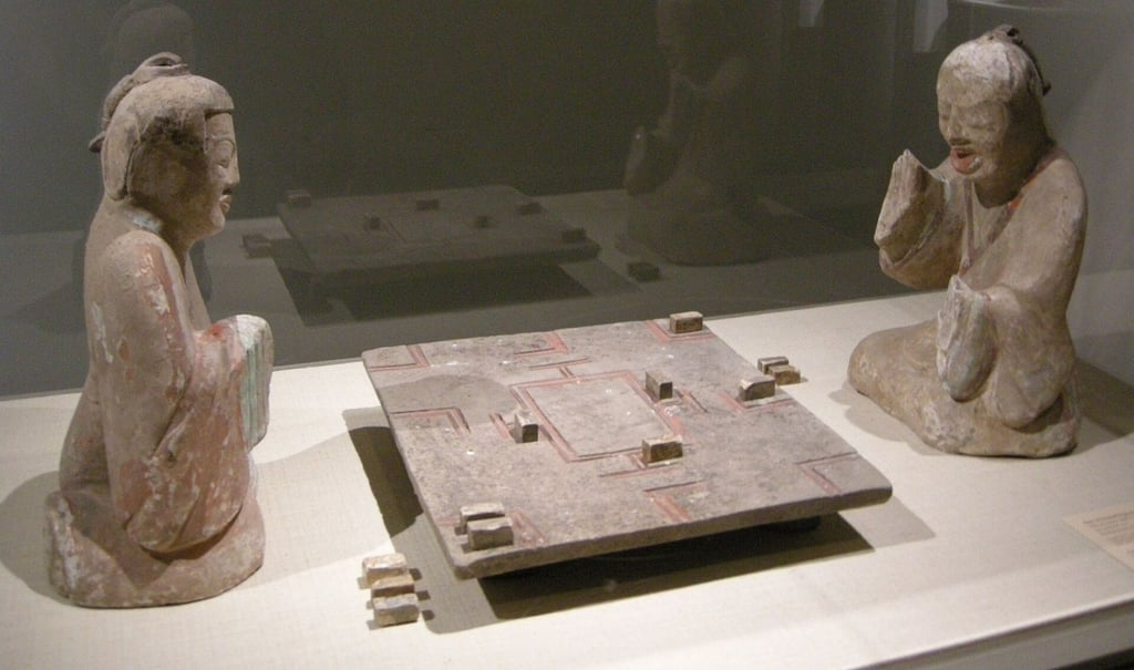 This exceptional Han dynasty (202 BC-220) earthenware sculpture at The Met captures two figures completely absorbed in a tense game of Liubo. Photo: Wikipedia This exceptional Han dynasty (202 BC-220) earthenware sculpture at The Met captures two figures completely absorbed in a tense game of Liubo. Photo: Wikipedia