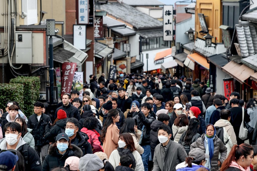 Tourists walk past shops and restaurants up the hill leading to Kiyomizu-dera temple in Kyoto in January 2025. Japan is targeting 60 million foreign tourists by 2030. Photo: AFP Tourists walk past shops and restaurants up the hill leading to Kiyomizu-dera temple in Kyoto in January 2025. Japan is targeting 60 million foreign tourists by 2030. Photo: AFP