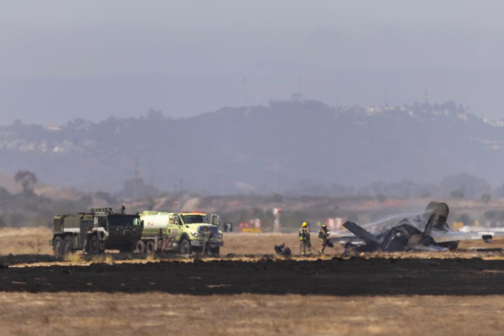 Crews work to douse a F-35 fighter jet that crashed near the runway at Marine Corps Air Station Miramar in San Diego on Friday. Photo: The San Diego Union-Tribune via AP Crews work to douse a F-35 fighter jet that crashed near the runway at Marine Corps Air Station Miramar in San Diego on Friday. Photo: The San Diego Union-Tribune via AP