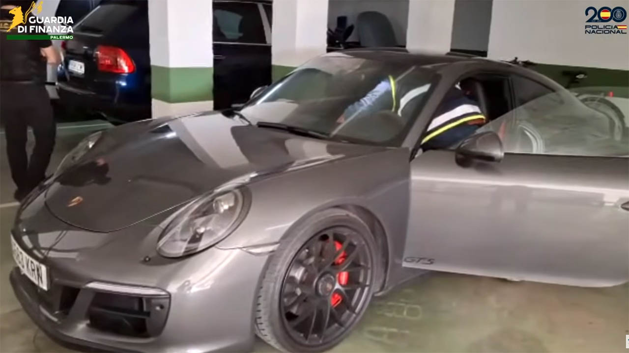 Screenshot from a video of police raids showing a seized Porsche sports car.