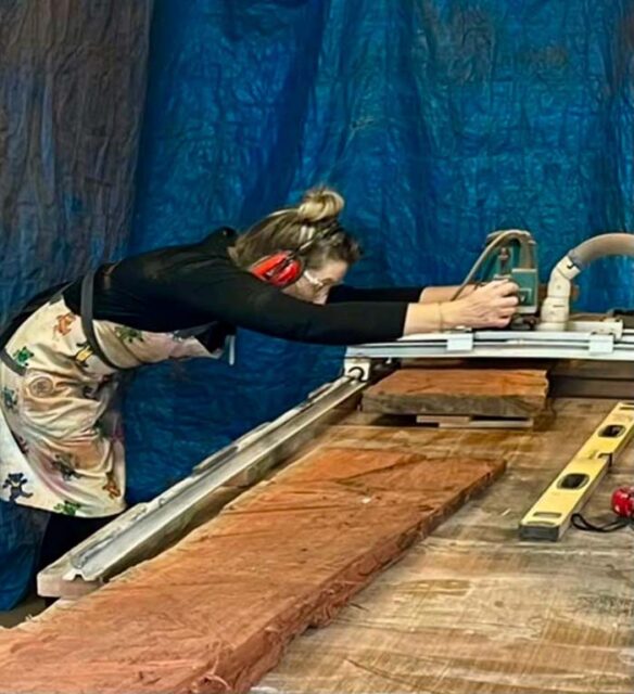 Photo of a woman using woodworking tools