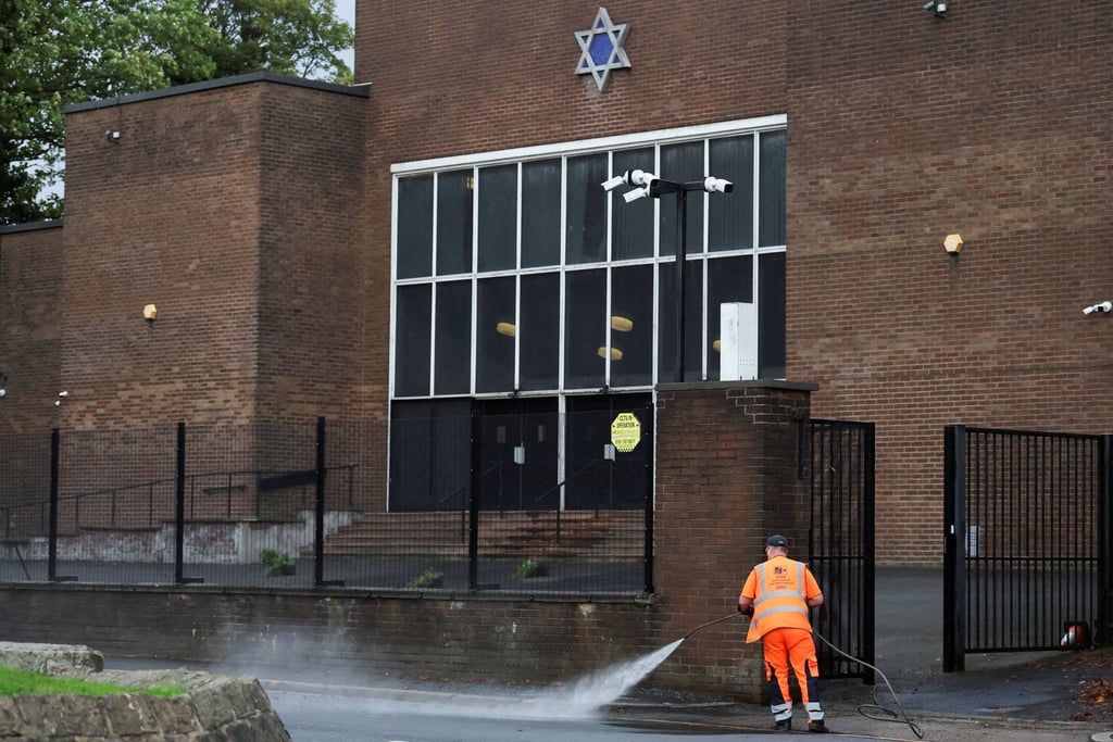 A worker cleans the area in front of the Manchester synagogue on October 5, where multiple people were killed on Yom Kippur, in what police have declared a terrorist incident. Photo: Reuters A worker cleans the area in front of the Manchester synagogue on October 5, where multiple people were killed on Yom Kippur, in what police have declared a terrorist incident. Photo: Reuters