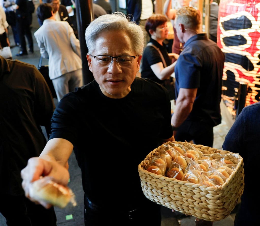 Nvidia CEO Jensen Huang hands out bread to journalists in front of a restaurant during a dinner in Tokyo on Wednesday. Photo: Reuters Nvidia CEO Jensen Huang hands out bread to journalists in front of a restaurant during a dinner in Tokyo on Wednesday. Photo: Reuters