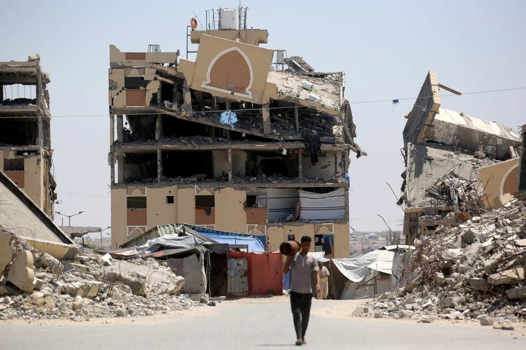 An internally displaced Palestinian man walks past the rubble of buildings destroyed by the Israeli military in Khan Younis on Tuesday. Photo: AFP An internally displaced Palestinian man walks past the rubble of buildings destroyed by the Israeli military in Khan Younis on Tuesday. Photo: AFP