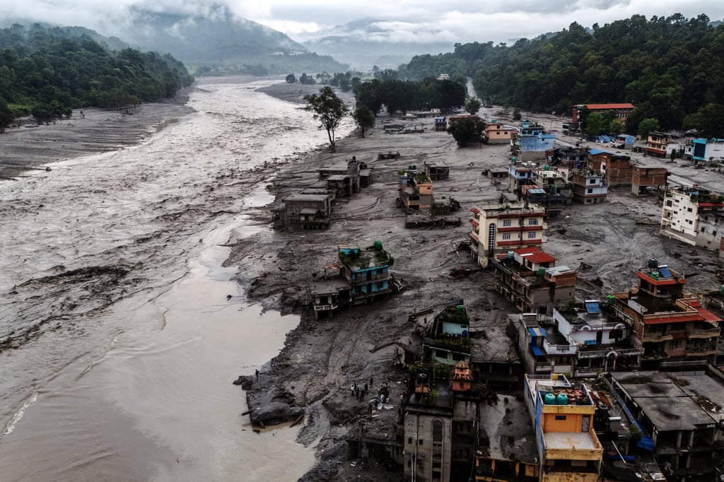 A drone view shows damaged buildings and mud-covered houses next to the Likhu River following deadly flash floods and mudslides in Devighat, in Nepal’s Nuwakot district, on Wednesday. Photo: Reuters A drone view shows damaged buildings and mud-covered houses next to the Likhu River following deadly flash floods and mudslides in Devighat, in Nepal’s Nuwakot district, on Wednesday. Photo: Reuters