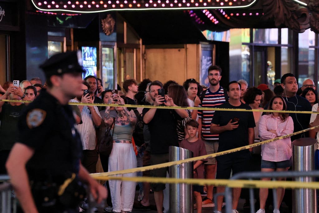 People gather as NYPD Commissioner Jessica Tisch and New York Mayor Zohran Mamdani hold a press conference at the crime scene in Times Square. Photo: Reuters People gather as NYPD Commissioner Jessica Tisch and New York Mayor Zohran Mamdani hold a press conference at the crime scene in Times Square. Photo: Reuters