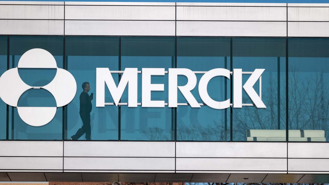Photo of Merck logo and sign on a glass window at the company's New Jersey headquarters.