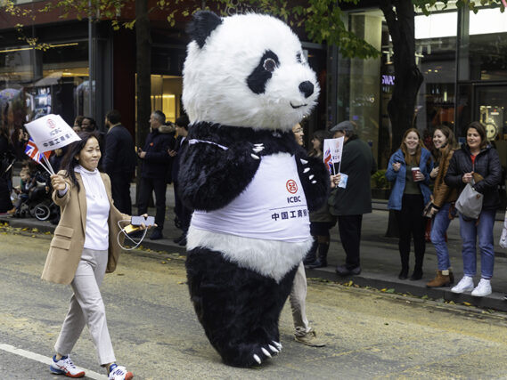 A pander in an ICBC T-shirt walking in a parade