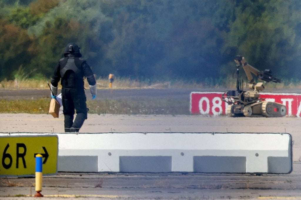A police officer in protective clothing walks next to an explosive-disarming robot at Leipzig/Halle Airport in August. Photo: Reuters A police officer in protective clothing walks next to an explosive-disarming robot at Leipzig/Halle Airport in August. Photo: Reuters