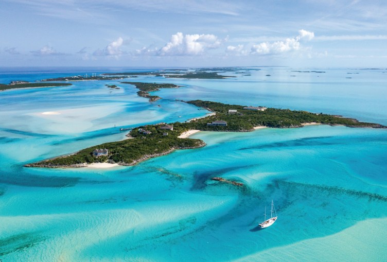 An aerial view of tropical islands surrounded by turquoise water.