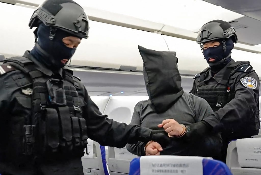 Chinese public security officers escort a suspected China-born scam boss off a plane after he was extradited from Cambodia in April. Photo: China’s Ministry of Public Security / AFP Chinese public security officers escort a suspected China-born scam boss off a plane after he was extradited from Cambodia in April. Photo: China’s Ministry of Public Security / AFP