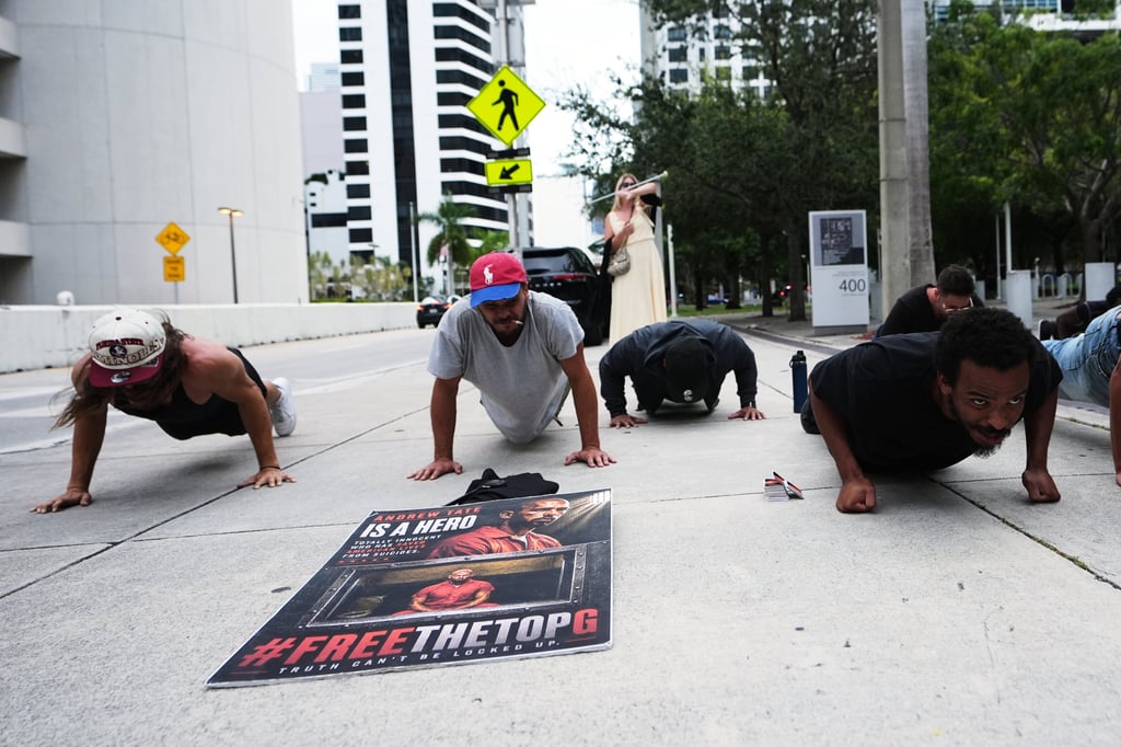 Supporters of Andrew and Tristan Tate do push-ups outside the courthouse in Miami in August. Photo: AP Supporters of Andrew and Tristan Tate do push-ups outside the courthouse in Miami in August. Photo: AP