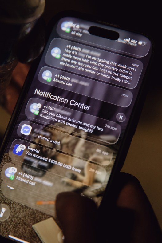 A close-up view shows a smartphone screen displaying text notifications requesting help with food and shelter.
