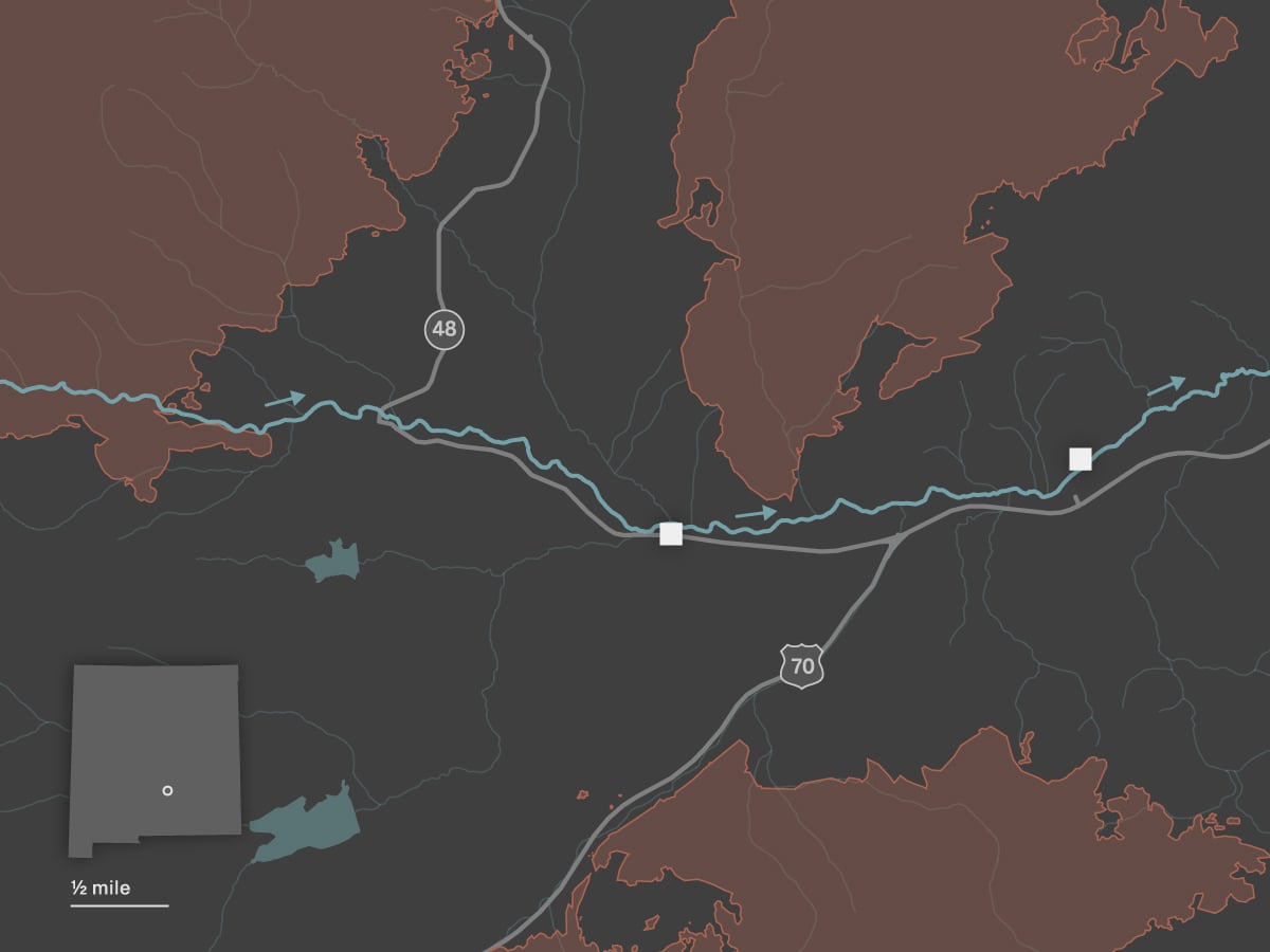 A map shows the towns of Ruidoso and Ruidoso Downs. The Rio Ruidoso runs from west to east through both towns. Two locations are identified along the river: the Riverview RV Park and a racetrack. The towns are surrounded by three large burn scars: the Salt Fire to the south, the South Fork Fire to the west and the McBride Fire to the north. 