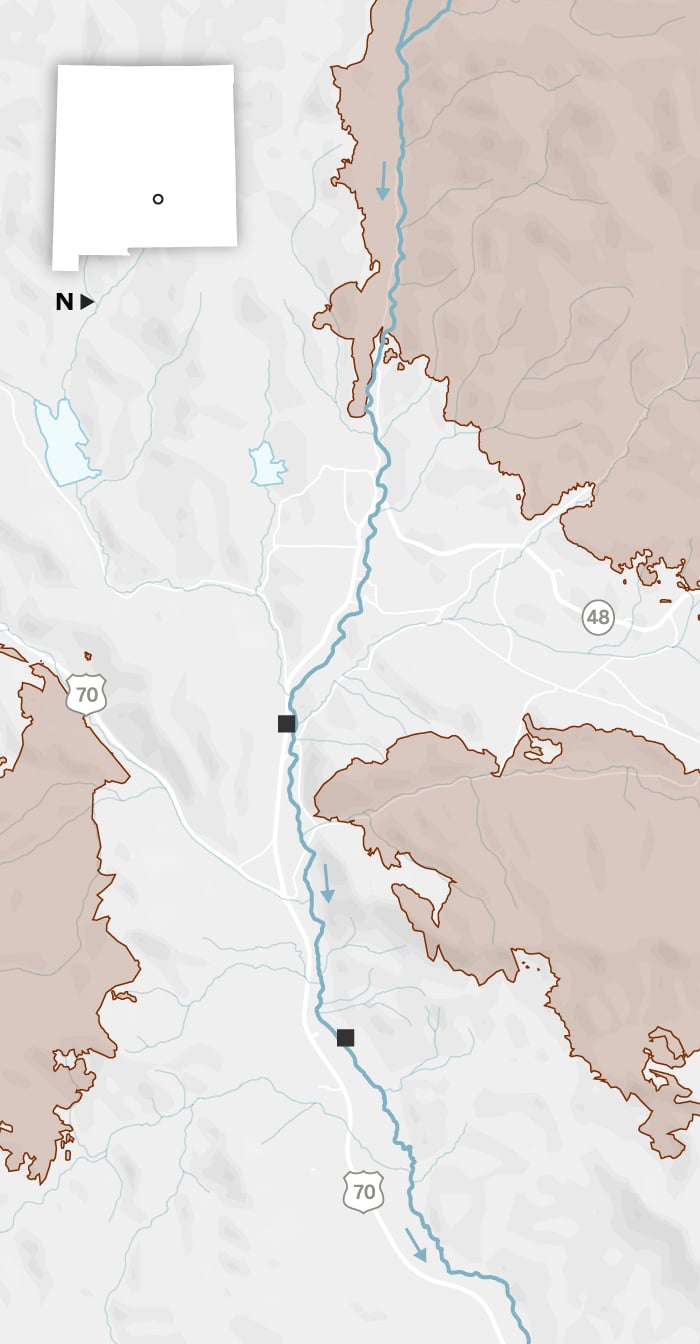 A map shows the towns of Ruidoso and Ruidoso Downs. The Rio Ruidoso runs from west to east through both towns. Two locations are identified along the river: the Riverview RV Park and a racetrack. The towns are surrounded by three large burn scars: the Salt Fire to the south, the South Fork Fire to the west and the McBride Fire to the north. 