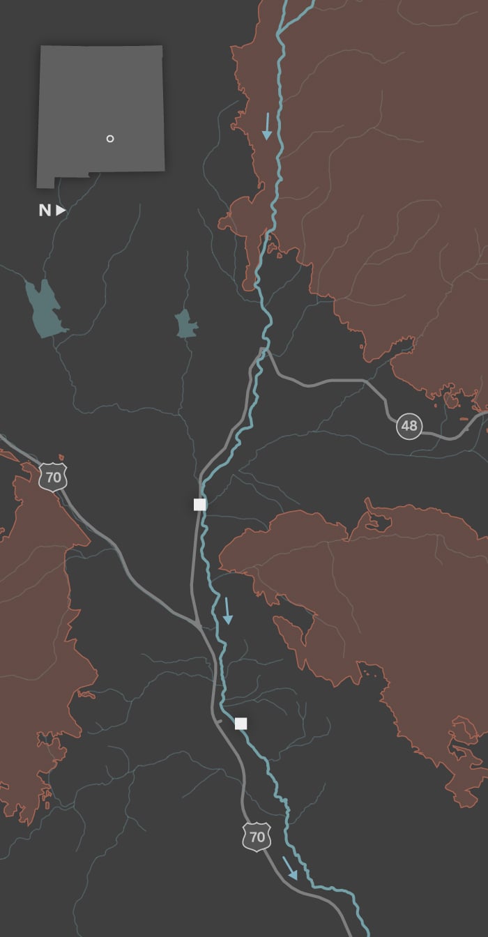 A map shows the towns of Ruidoso and Ruidoso Downs. The Rio Ruidoso runs from west to east through both towns. Two locations are identified along the river: the Riverview RV Park and a racetrack. The towns are surrounded by three large burn scars: the Salt Fire to the south, the South Fork Fire to the west and the McBride Fire to the north. 